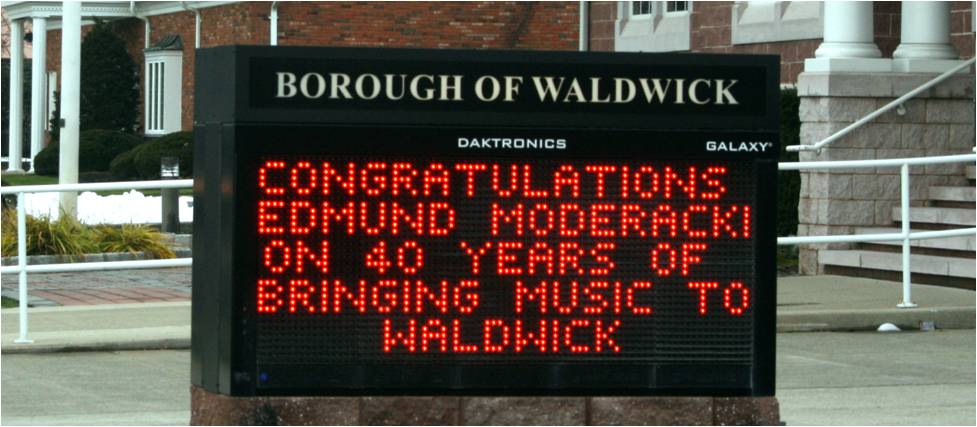 sign recognizing ed moderacki's 40 years as director